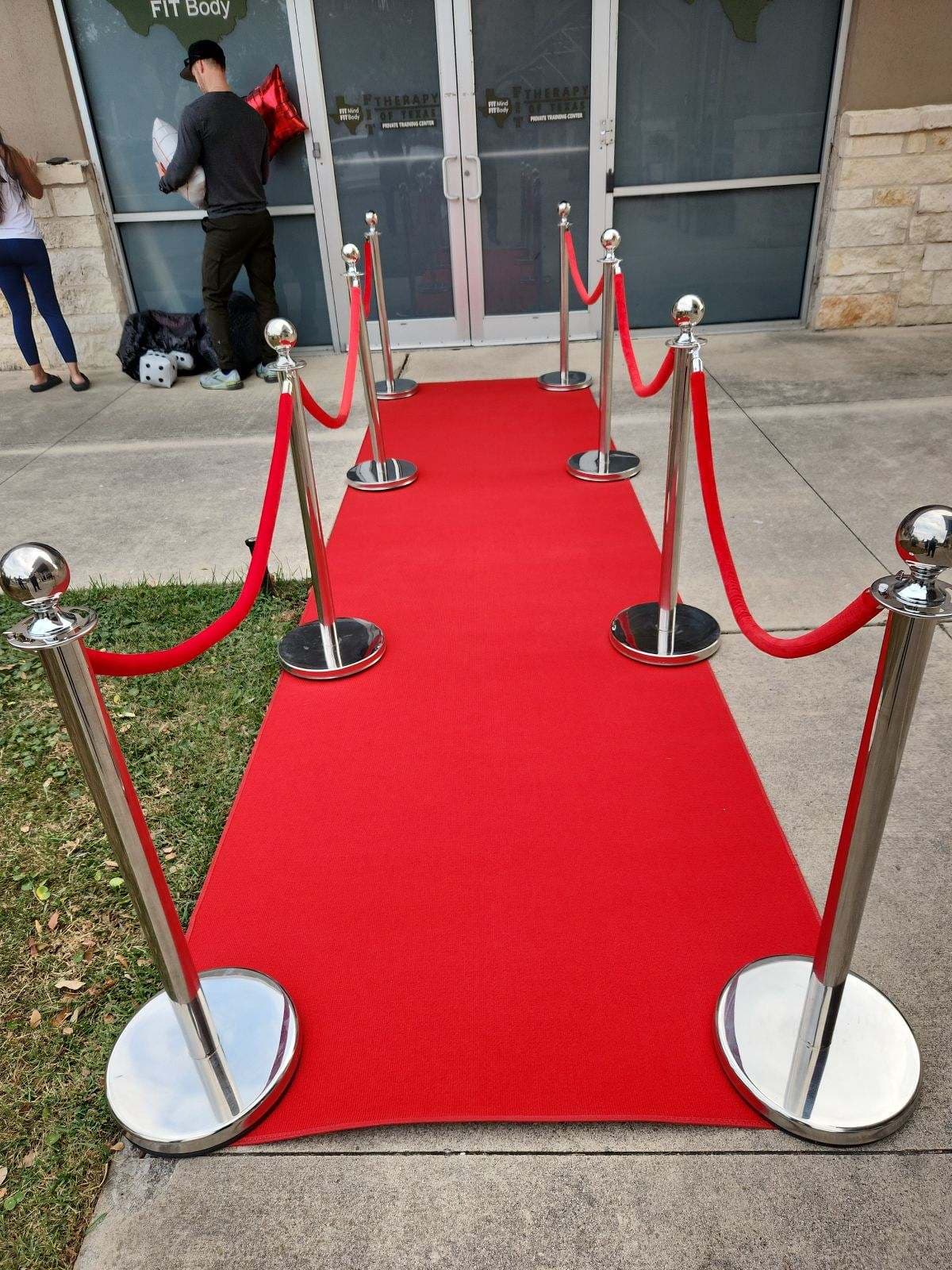 Red rope stanchions with red carpet entrance